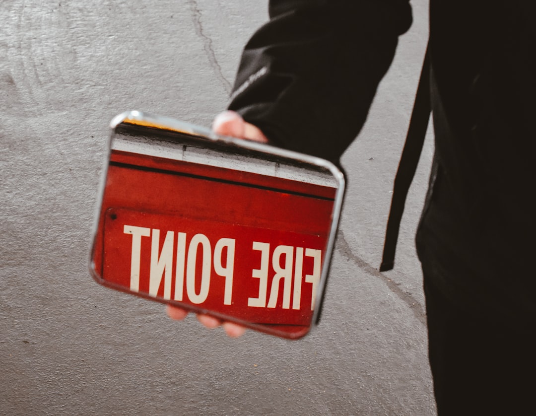 person holding a mirror with fire point reflected