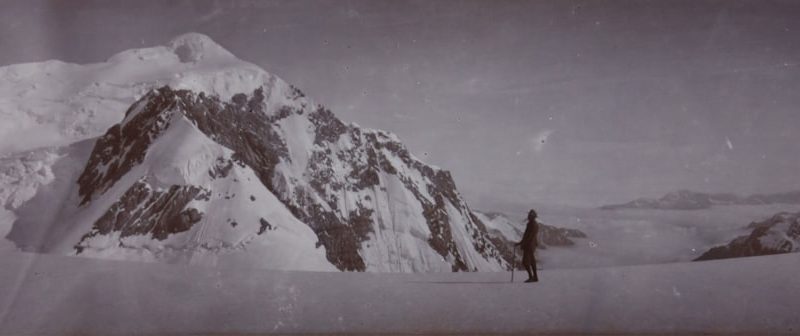 a man standing on top of a snow covered mountain