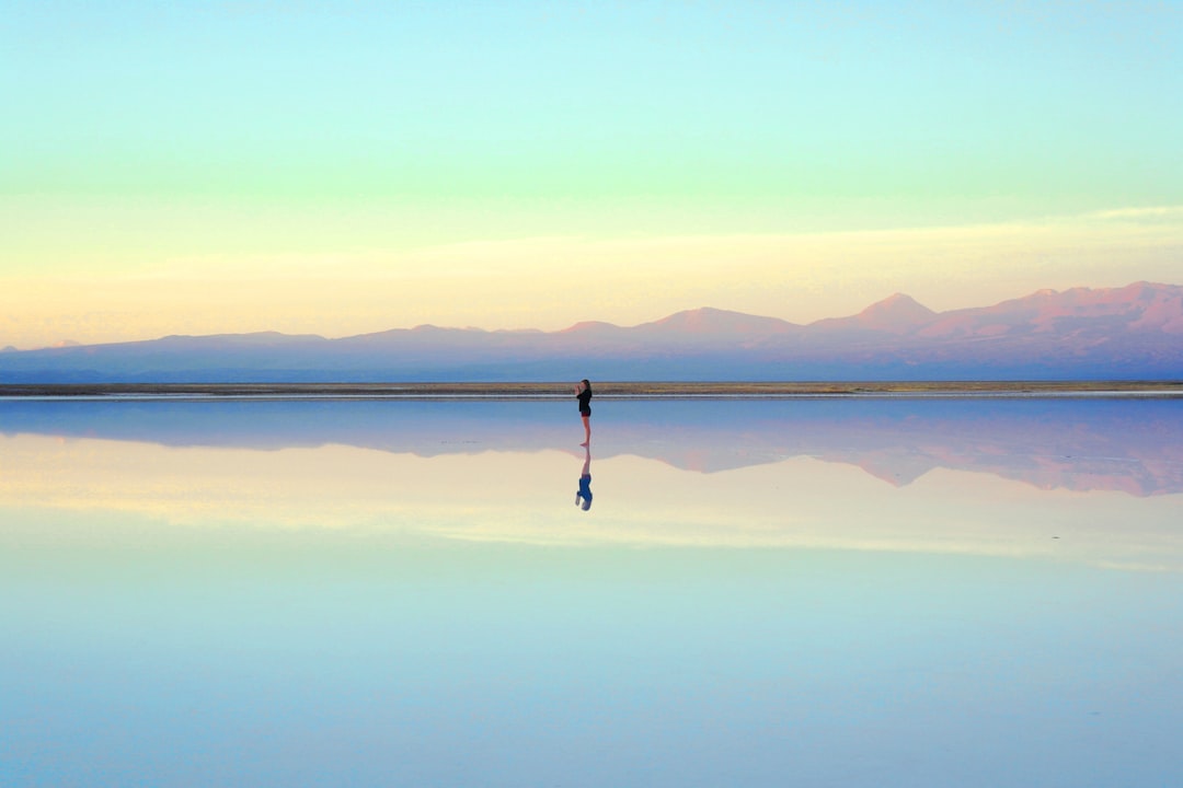 person standing near body of water during daytime