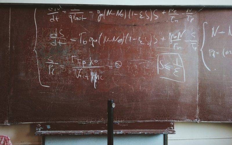 written equations on brown wooden board