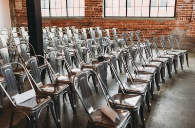 a room filled with lots of metal chairs