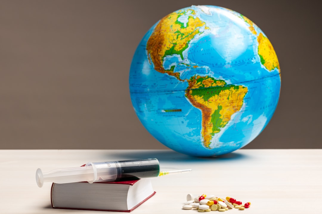 blue and green globe on white table