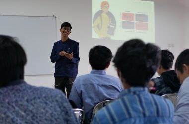 a man standing in front of a group of people