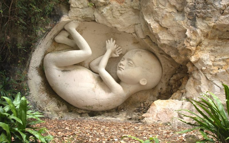 a statue of a baby in a cave