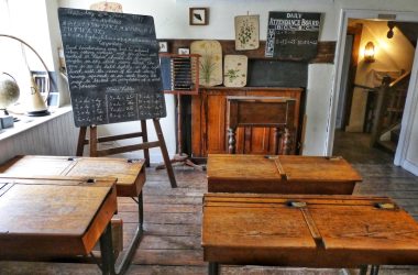 four brown desks inside room