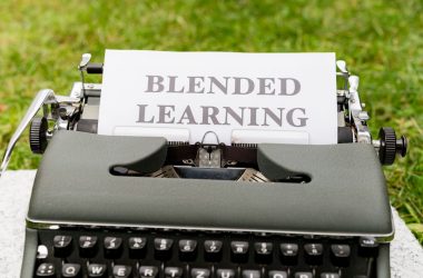 a typewriter with a sign that reads blended learning