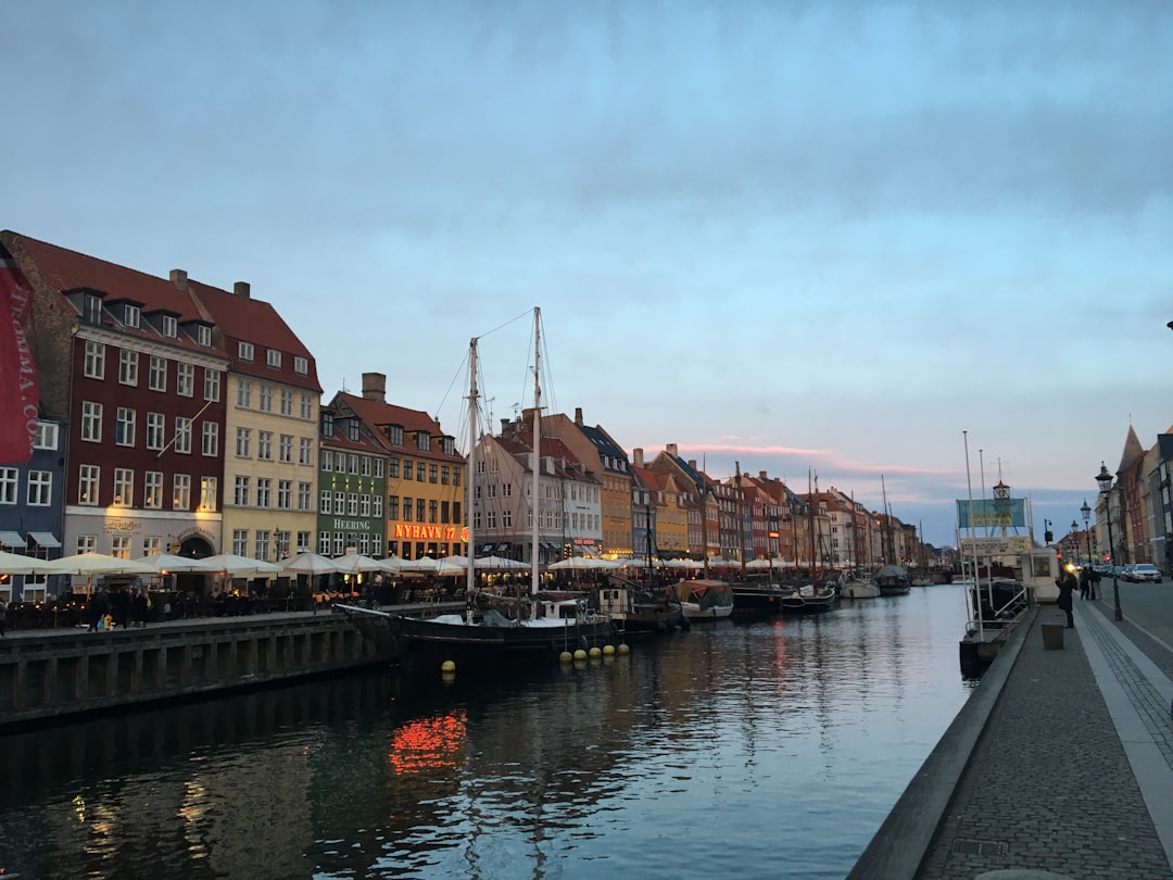 a harbor filled with lots of boats next to tall buildings