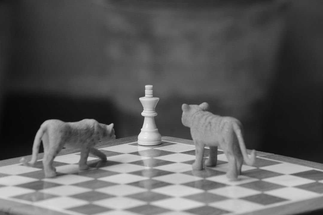 a chess board with two toy animals on it