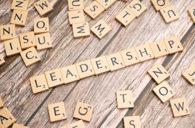 scrabble tiles spelling out the word leadership on a wooden surface