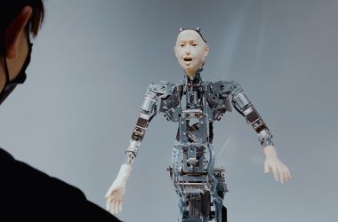 a woman looking at a robot in the air