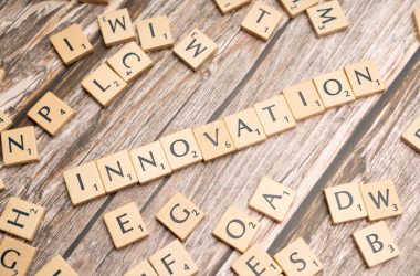 scrabble tiles spelling the word innovation on a wooden surface