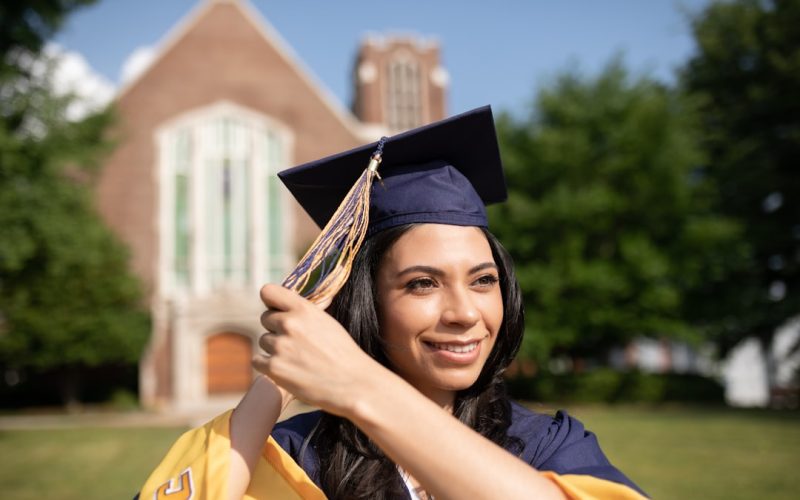 a woman in a graduation cap and gown