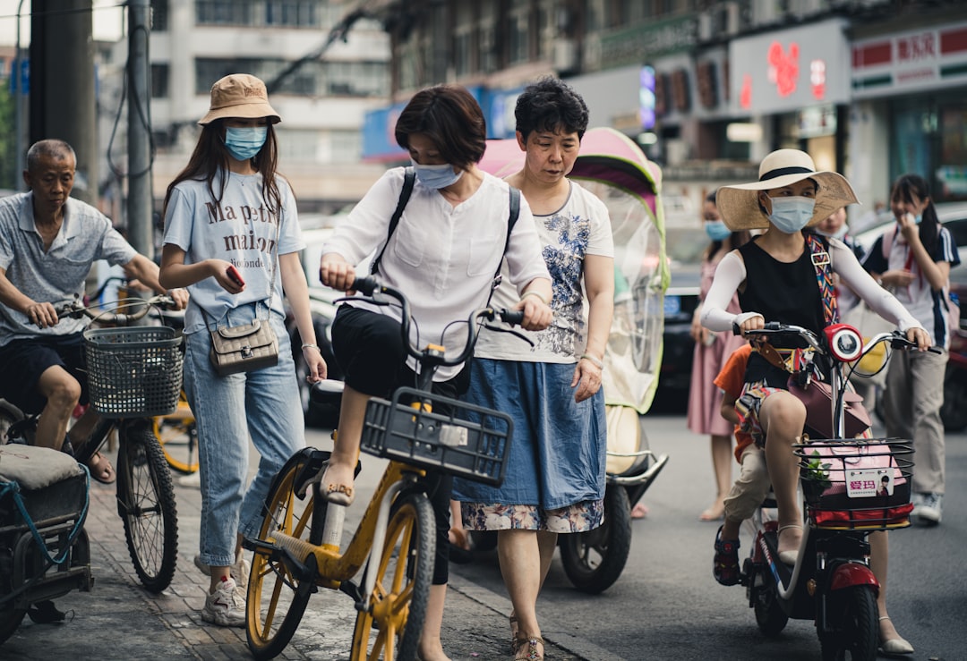 woman in white shirt and blue denim skirt riding on motorcycle during daytime