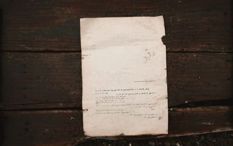 white printer paper on brown wooden surface
