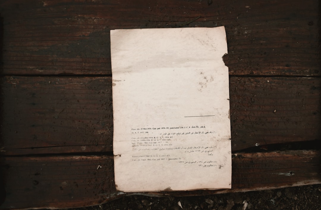 white printer paper on brown wooden surface