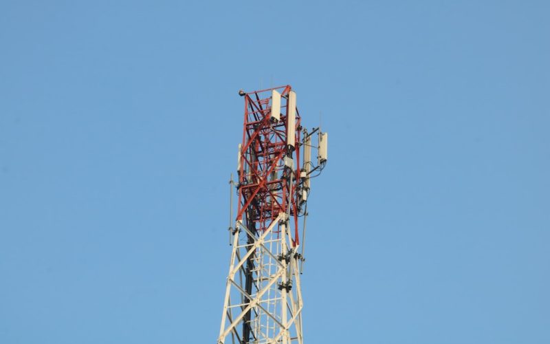 a cell phone tower with a blue sky in the background
