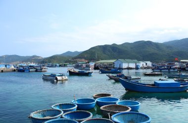 boat near port and mountain during daytime