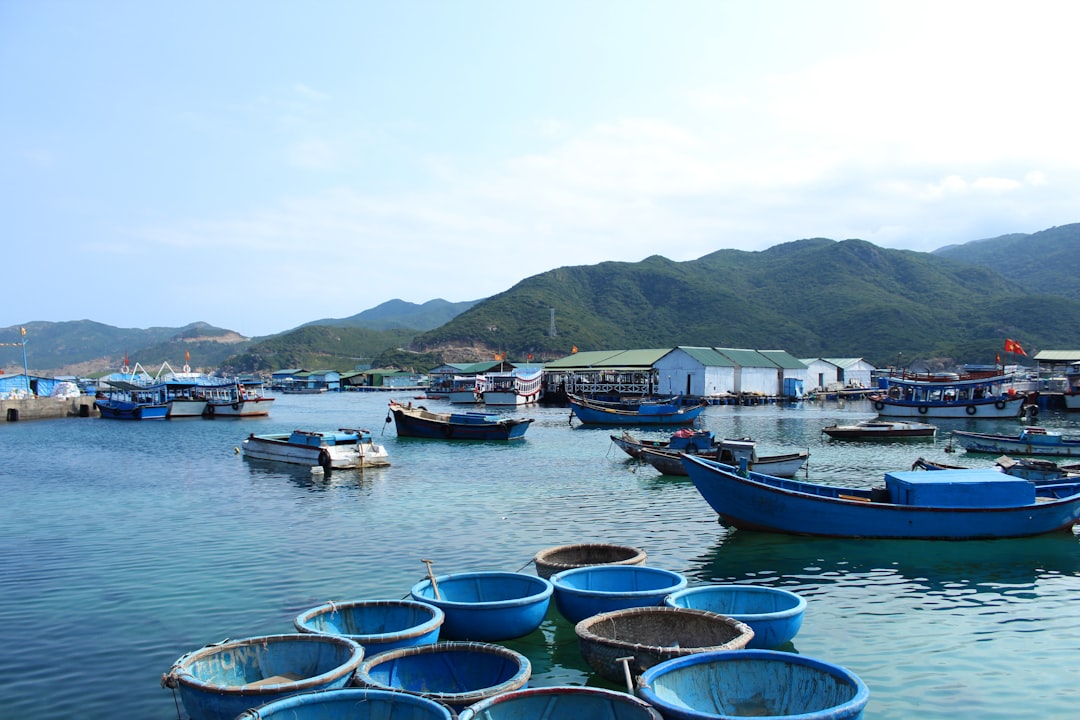 boat near port and mountain during daytime