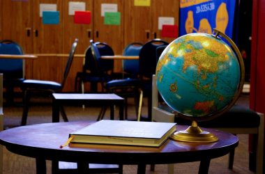 a globe sits on a table in a classroom