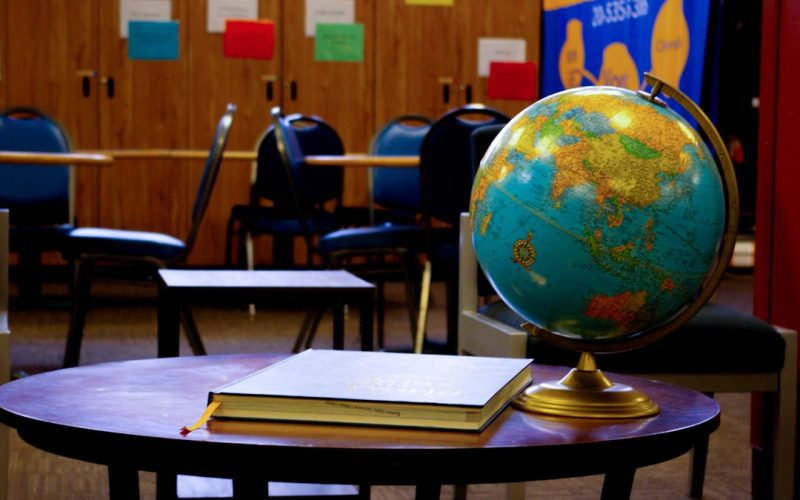 a globe sits on a table in a classroom