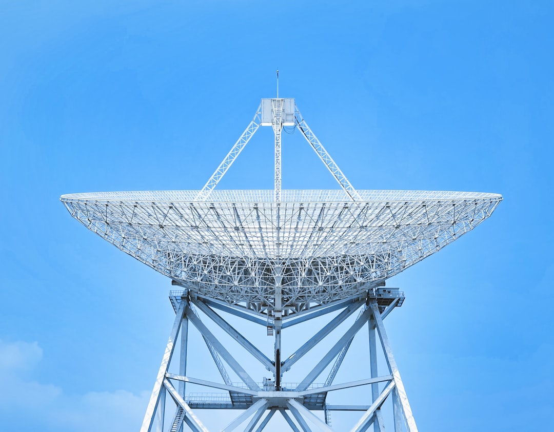 white satellite dish under blue sky during daytime