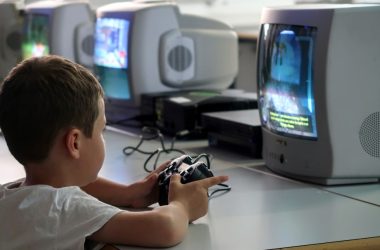 a young boy playing a video game on a nintendo wii