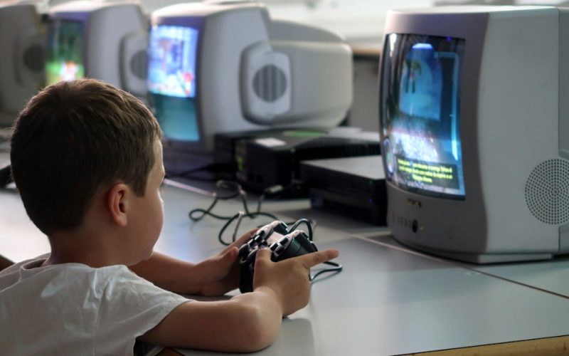 a young boy playing a video game on a nintendo wii