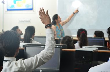 Students and teacher in a computer classroom.