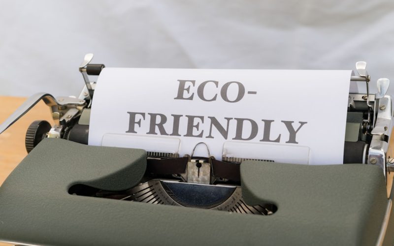 a close up of a typewriter with a paper that reads eco - friendly