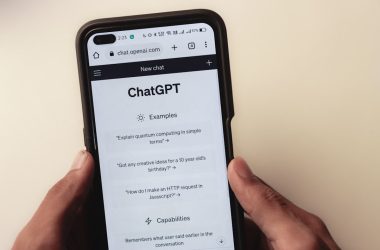 a person holding a cell phone with a chat app on the screen