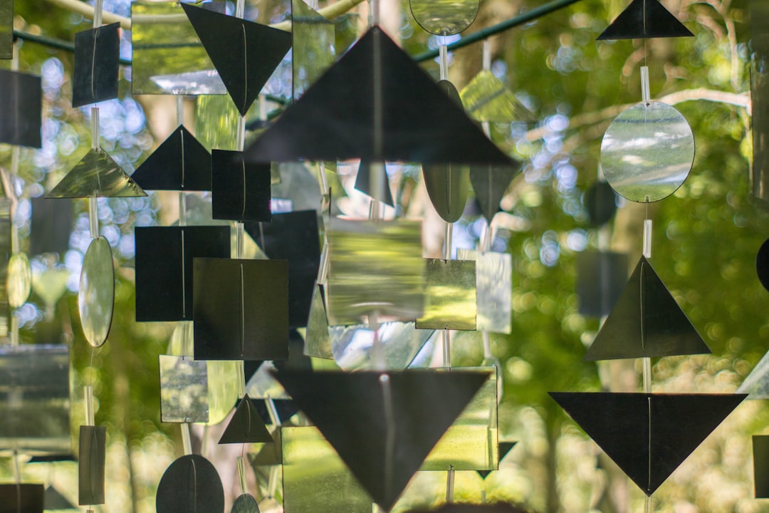 a close up of a wind chime hanging from a tree