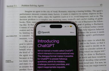 a cell phone sitting on top of an open book