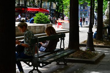 A couple of people sitting on a bench