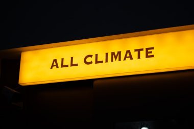 a yellow sign that says all climate on it