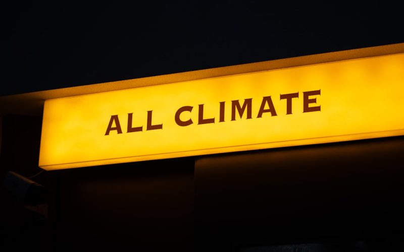 a yellow sign that says all climate on it