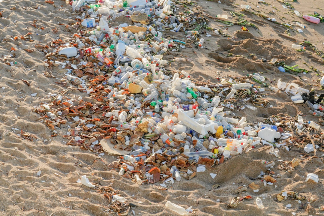 A beach covered in lots of plastic bottles and debris