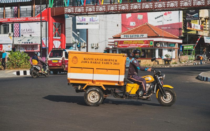 a man on a motorcycle driving down a street