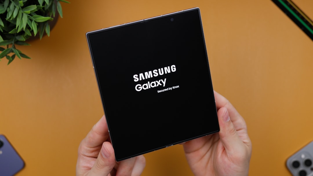 A person holding a black box with the samsung logo on it