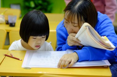 woman teaching girl
