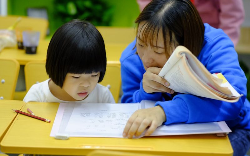woman teaching girl