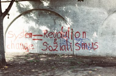 a concrete wall with graffiti