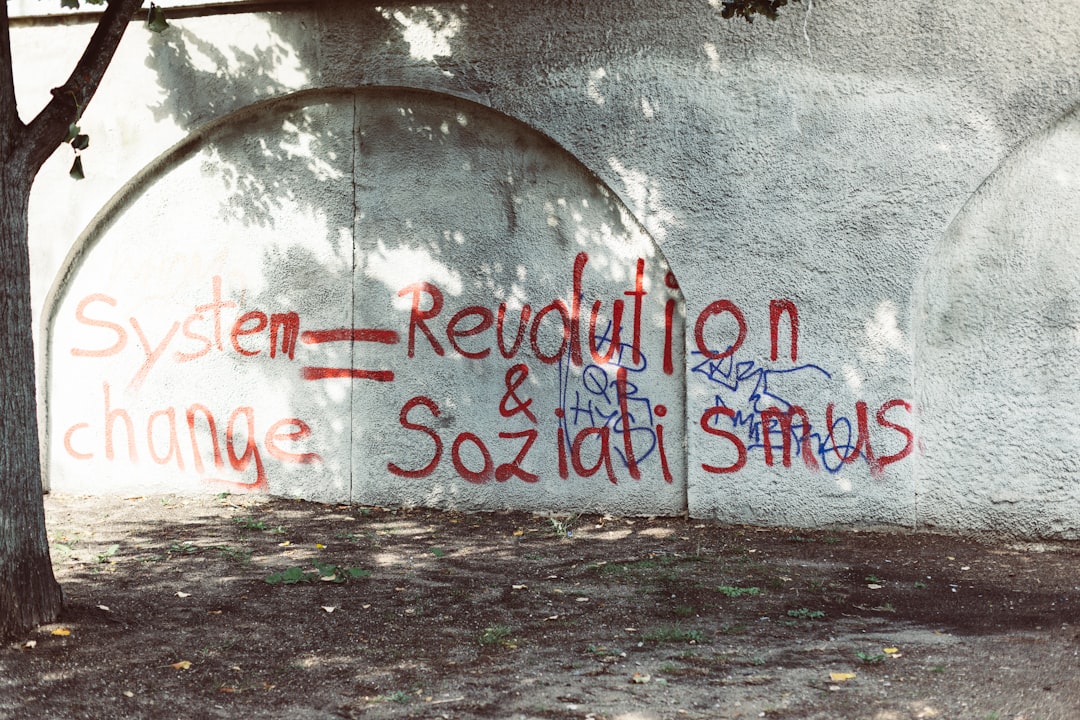 a concrete wall with graffiti