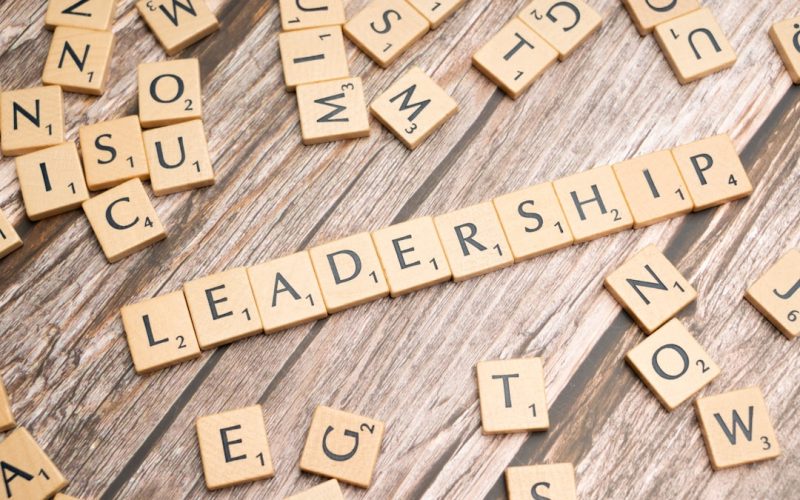 scrabble tiles spelling out the word leadership on a wooden surface