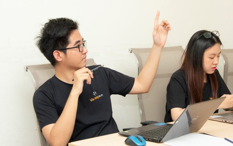 man in black crew-neck shirt sitting beside woman