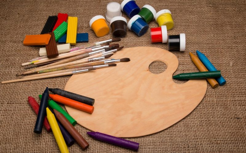 assorted color pen on brown wooden table