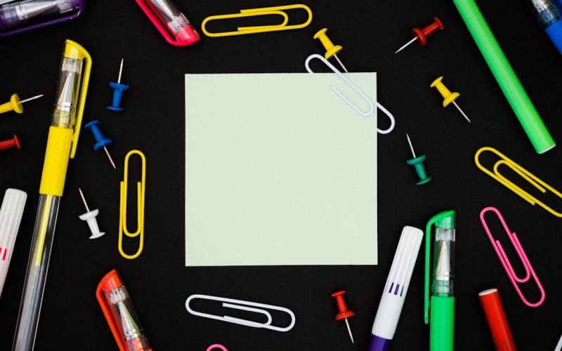 yellow and pink pen on gray paper