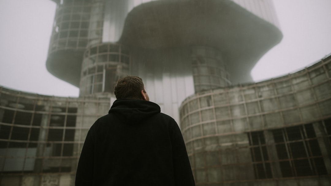 a man looking at a large sphere