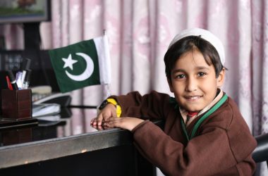a young girl holding a yellow flag