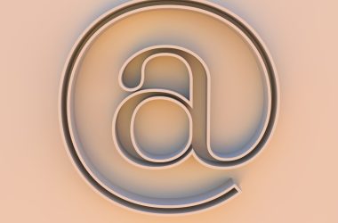 An "at" symbol on a beige background.