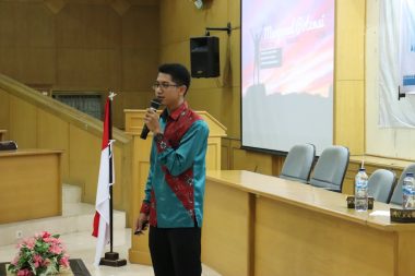 a man standing in front of a podium holding a microphone